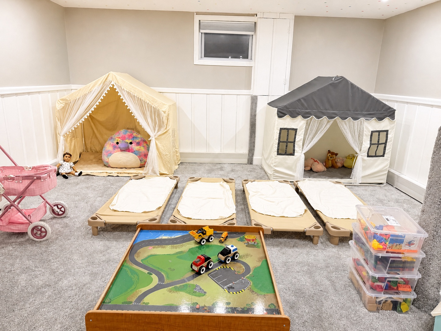 The actual Bluebird Learning Nest toddler napping area with four child-sized cots and two quiet play tents